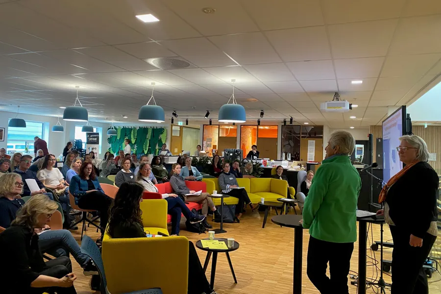 A group of people sitting in a room