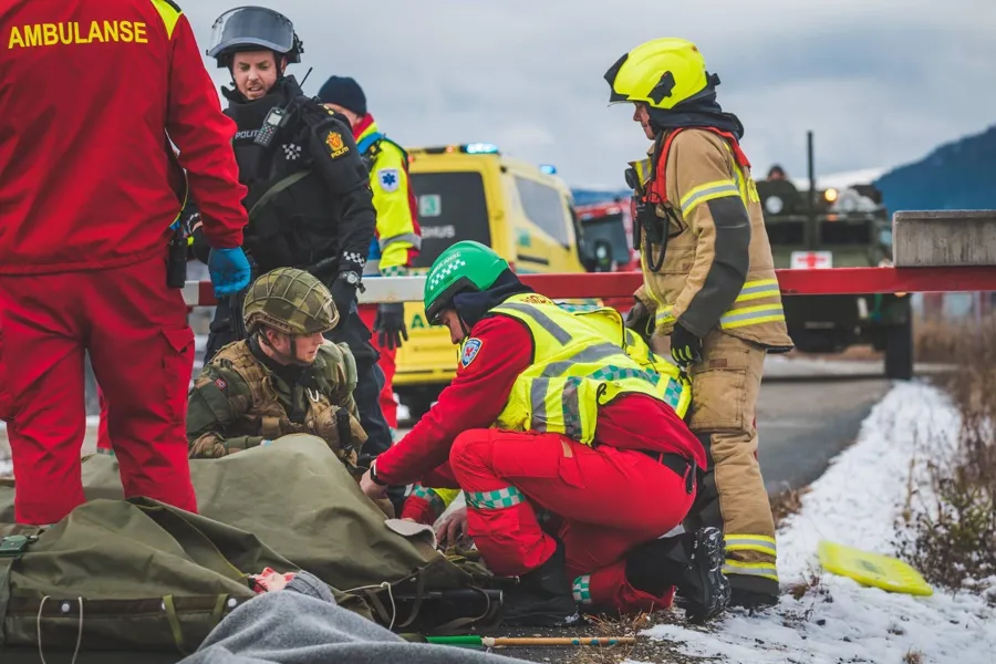 A photo of an accident scene with several emergency services and people present