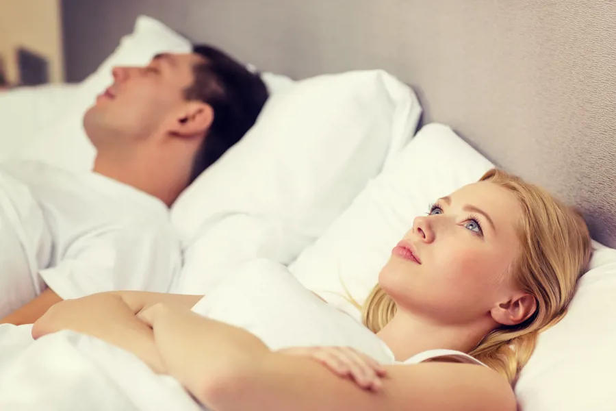 Mann og kvinne i seng. Foto