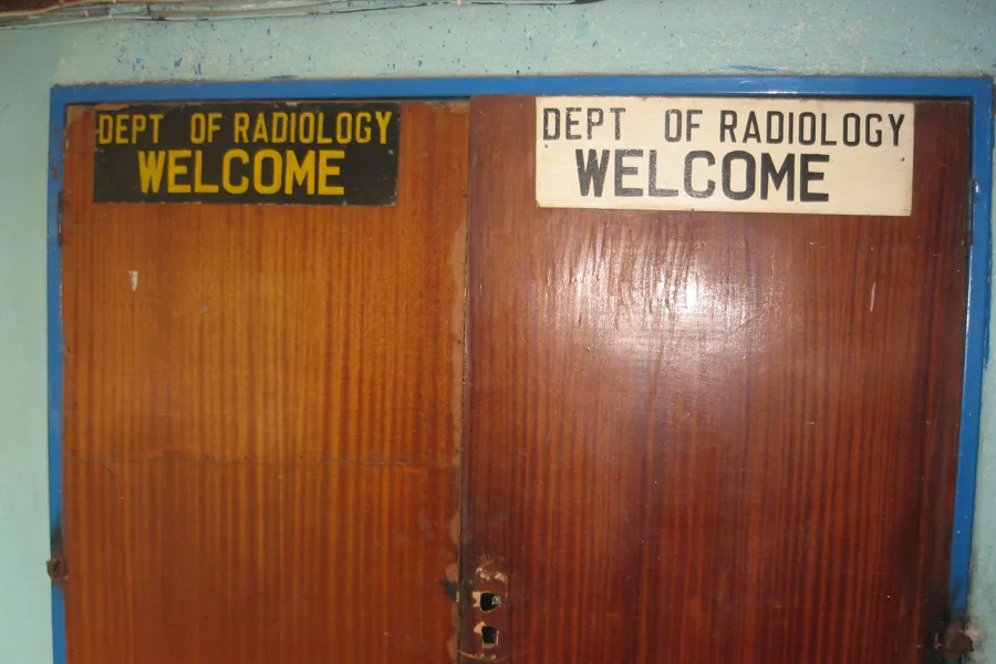 A wooden door with a sign on it