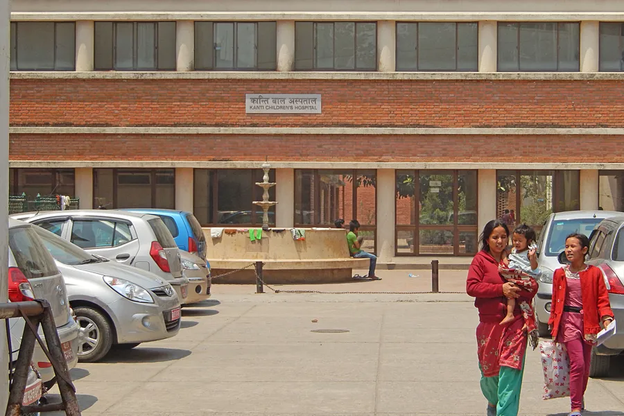 A group of people walking outside a building