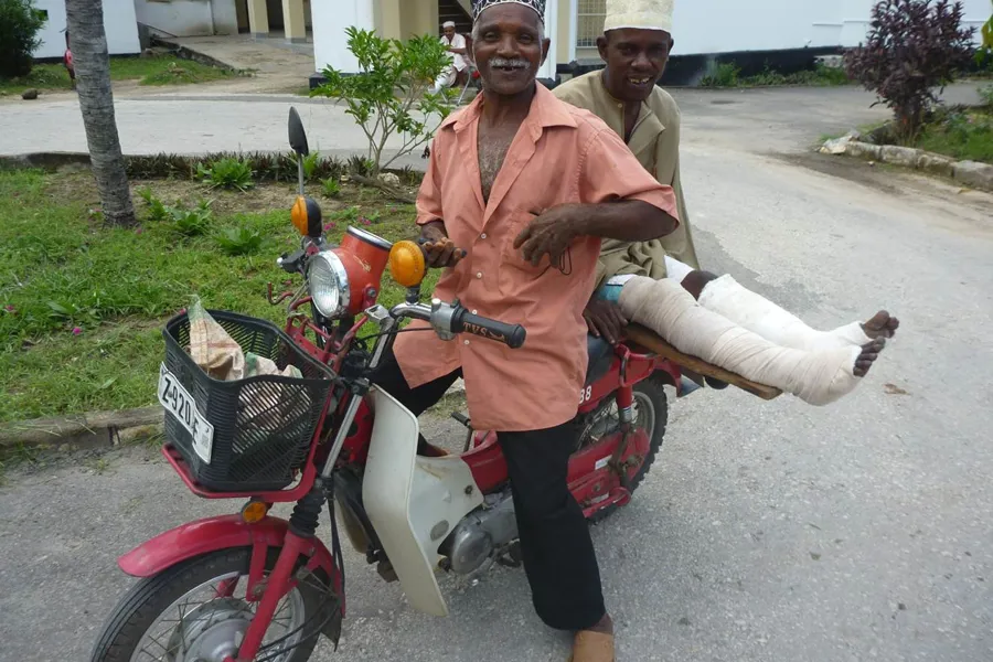 A couple of men on a motorcycle