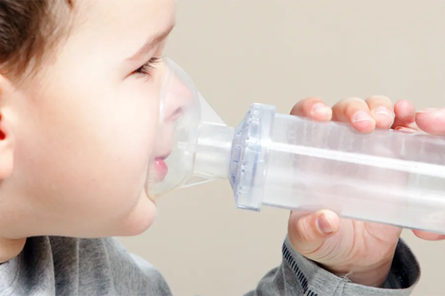 Little boy with asthma inhalor