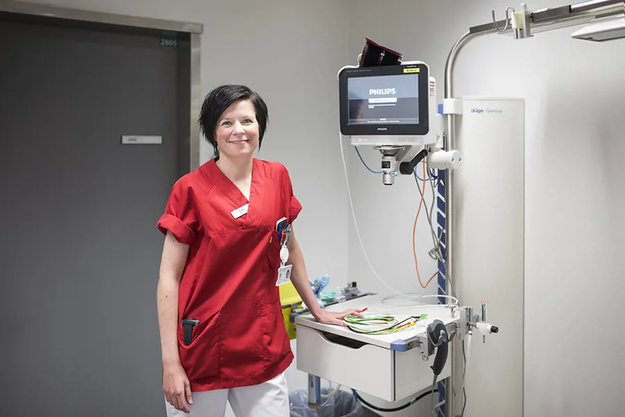 Sykepleier i rød kittel i mottaksrom Akuttmottak