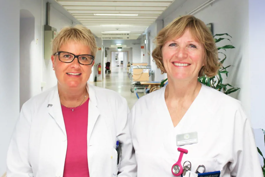 To smilande kvinnelege tilsette i sjukehuskorridor.
