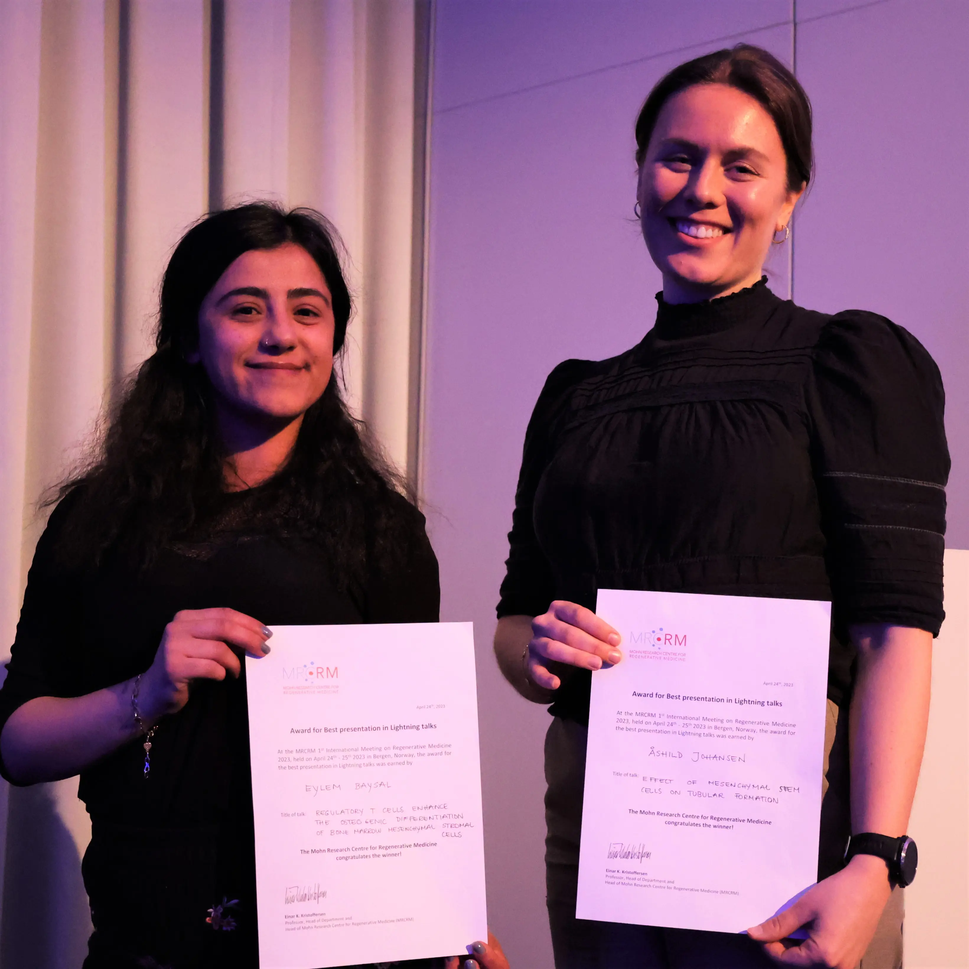 A couple of women holding a certificate